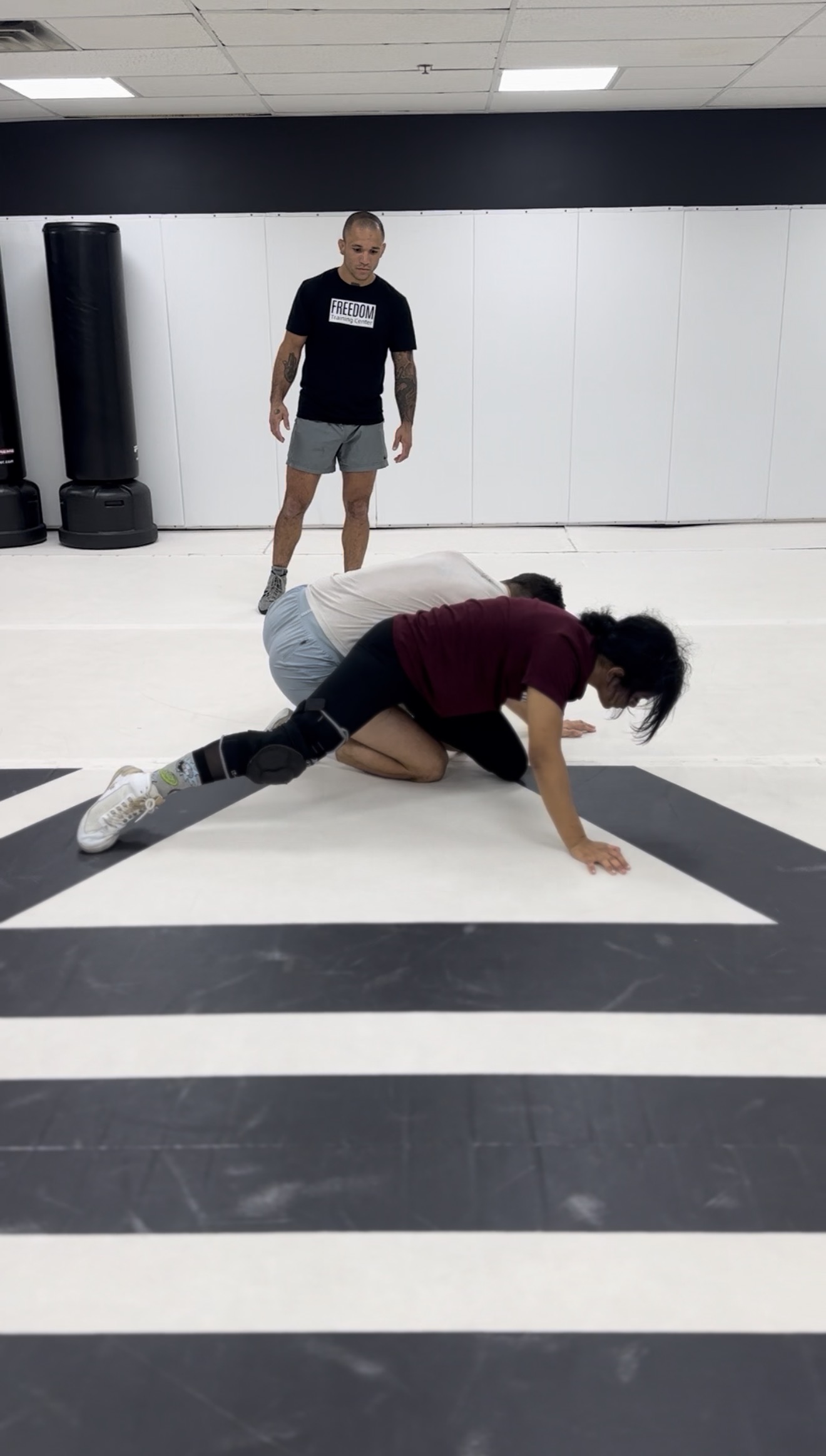 Coach Eric watching members work a takedown drill