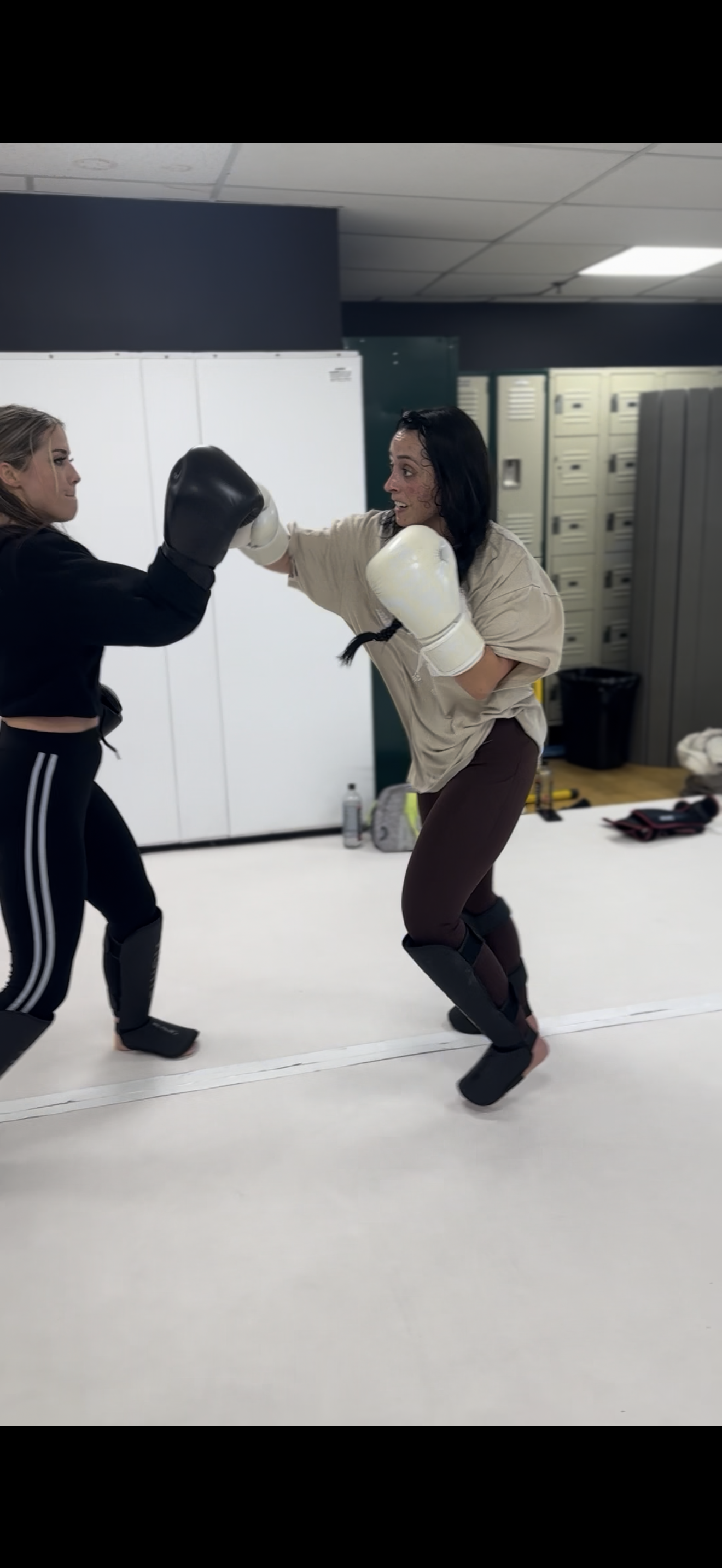 Two women sparring during a self-defense session